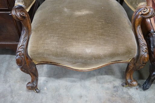 A Victorian carved walnut upholstered spoonback open armchair, width 66cm, depth 72cm, height 98cm